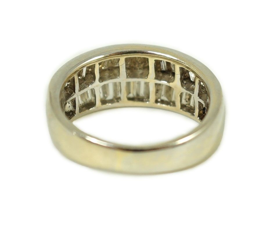 A modern 18k white gold and two row graduated baguette cut diamond set half hoop ring